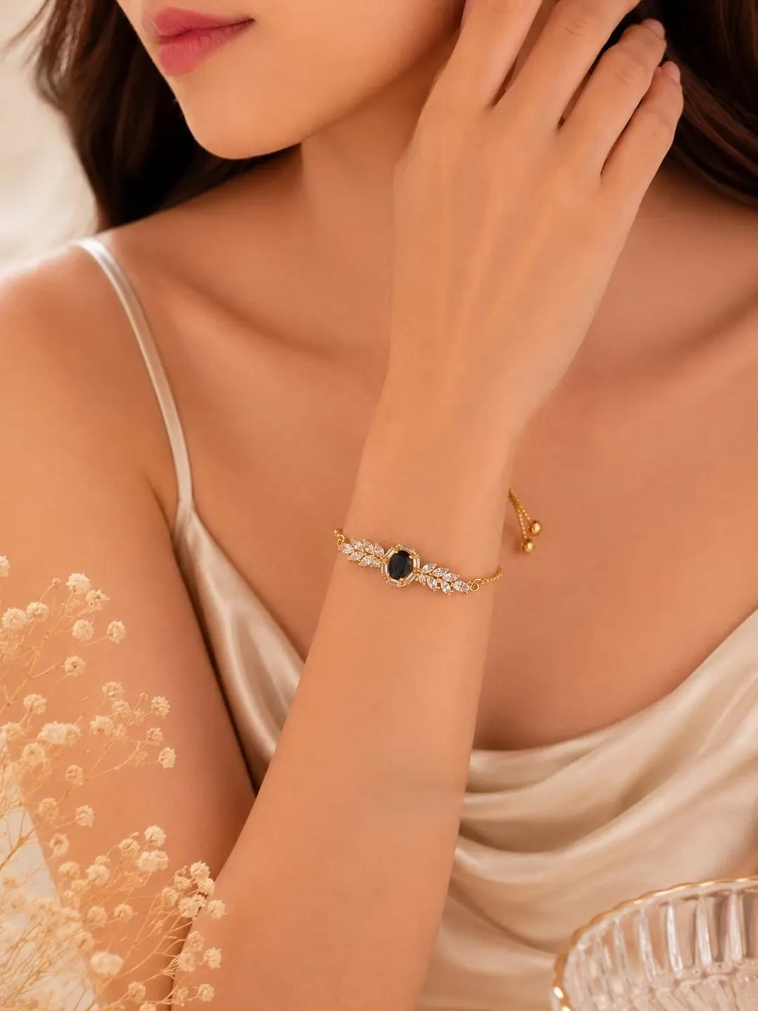 GOLD-TONE BLACK CENTER STONE AND CRYSTAL HALO ADJUSTTABLE BRACELET