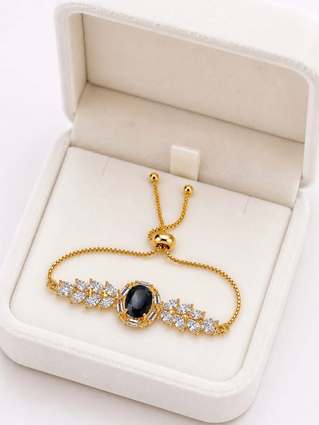 GOLD-TONE BLACK CENTER STONE AND CRYSTAL HALO ADJUSTTABLE BRACELET