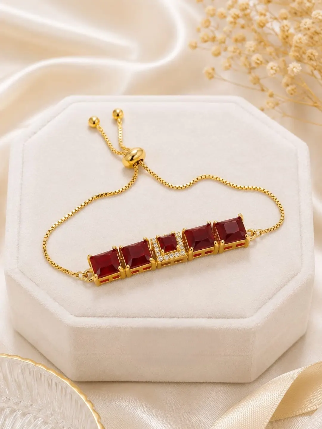 RUBY RED RECTANGULAR STONE GOLD-PLATED BRACELET.
