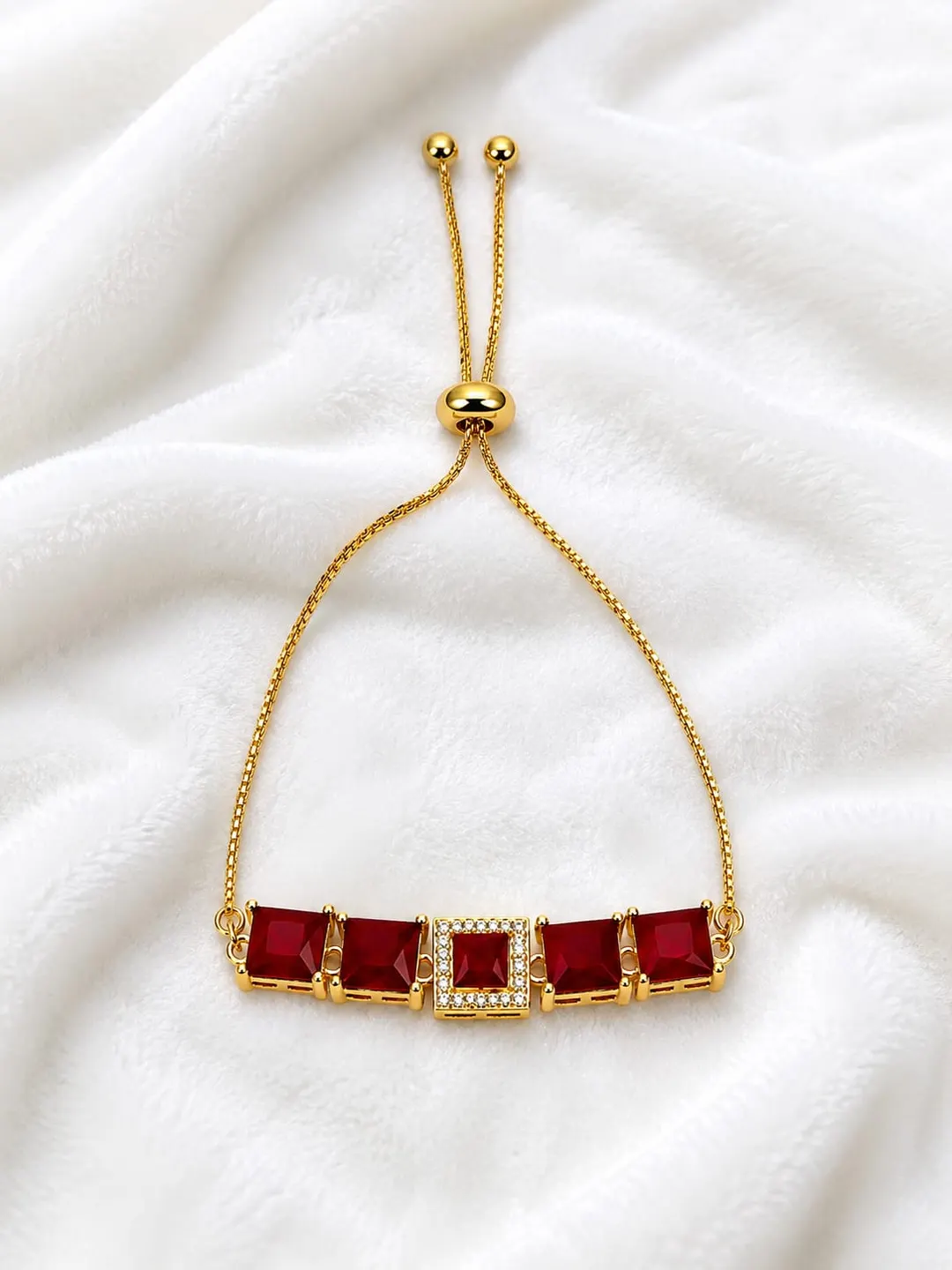 RUBY RED RECTANGULAR STONE GOLD-PLATED BRACELET.