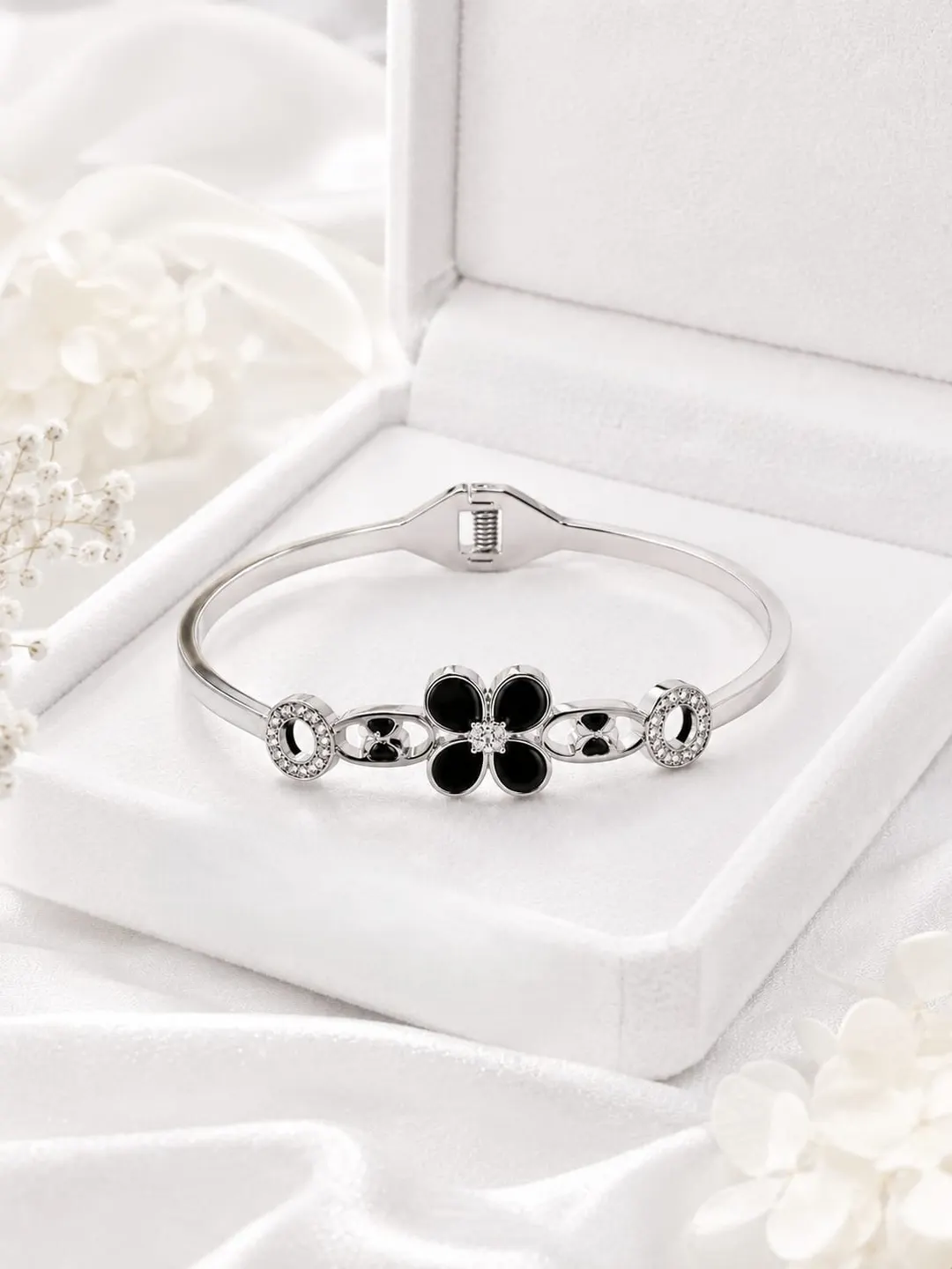 SILVER-TONE BLACK CLOVER HINGED BRACELET.