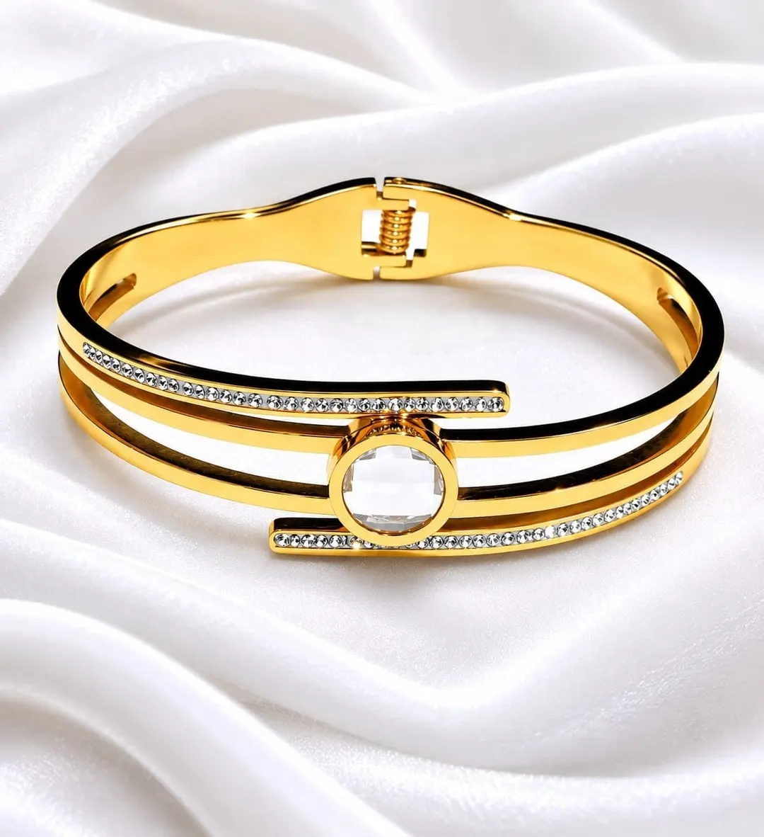 GOLD PLATED STAINLESS STEEL OVAL HINGED CUFF BRACELET.