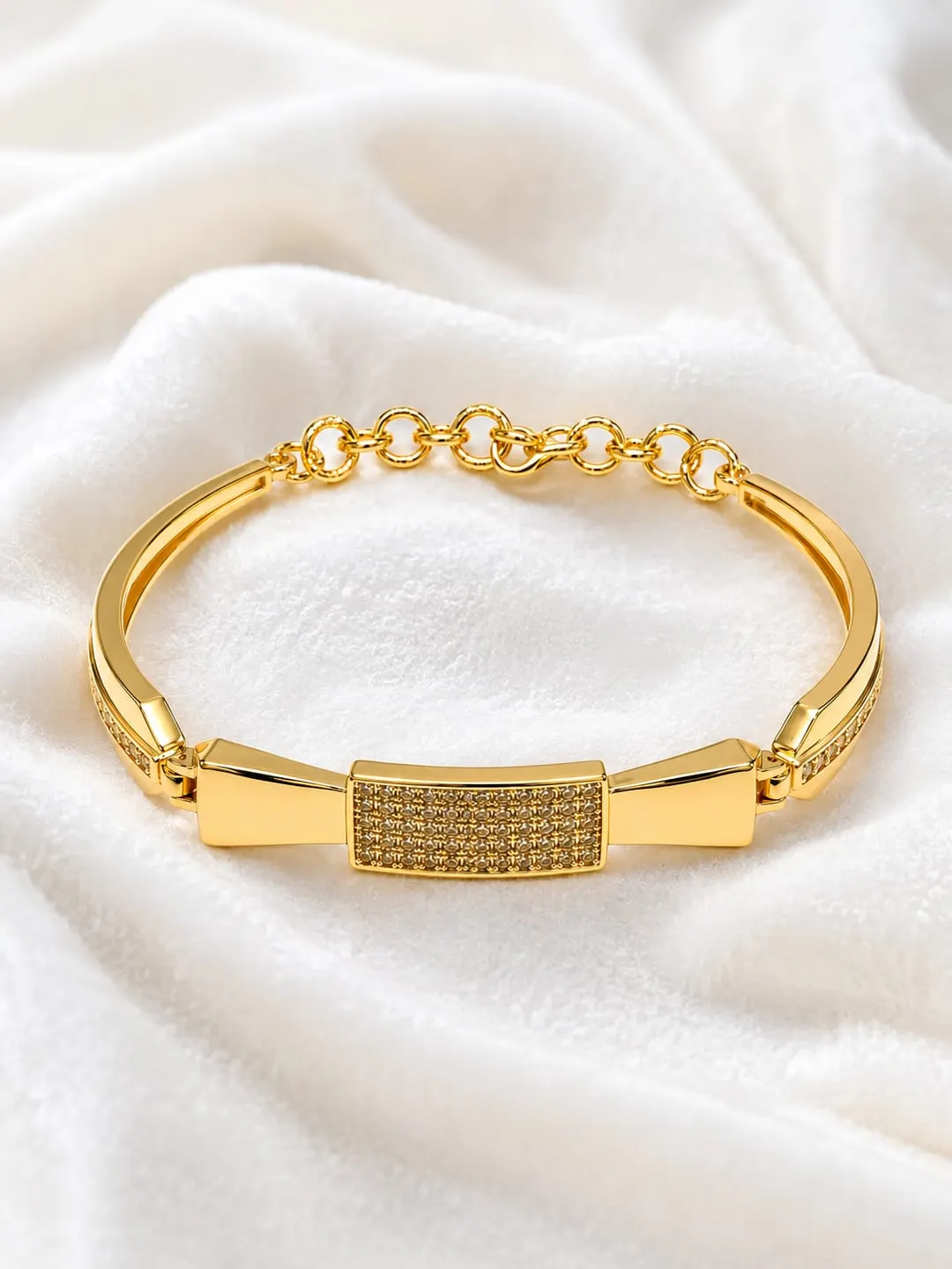 GOLD PLATED CUBIC ZIRCONIC [CZ] AMERICAN DIAMOND STUDDED BOW DESIGN BRACELET.