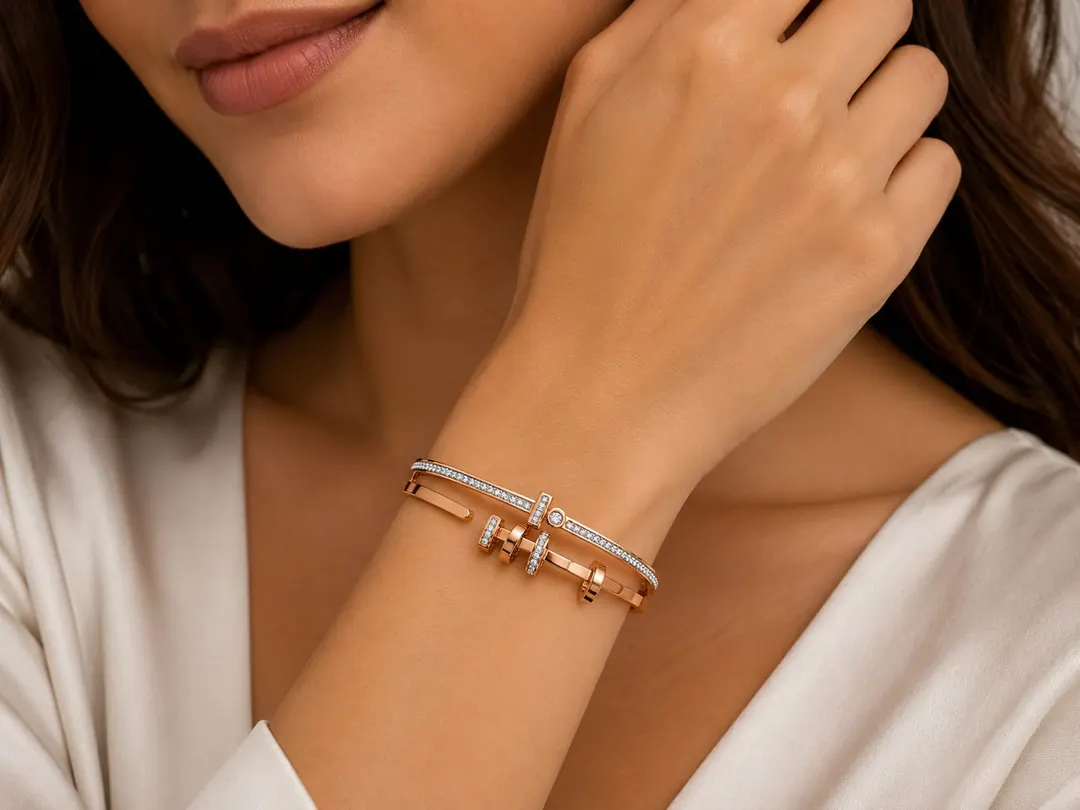 ROSE GOLD PLATED TITANIUM STAINLESS STEEL HINGED BRACELET.