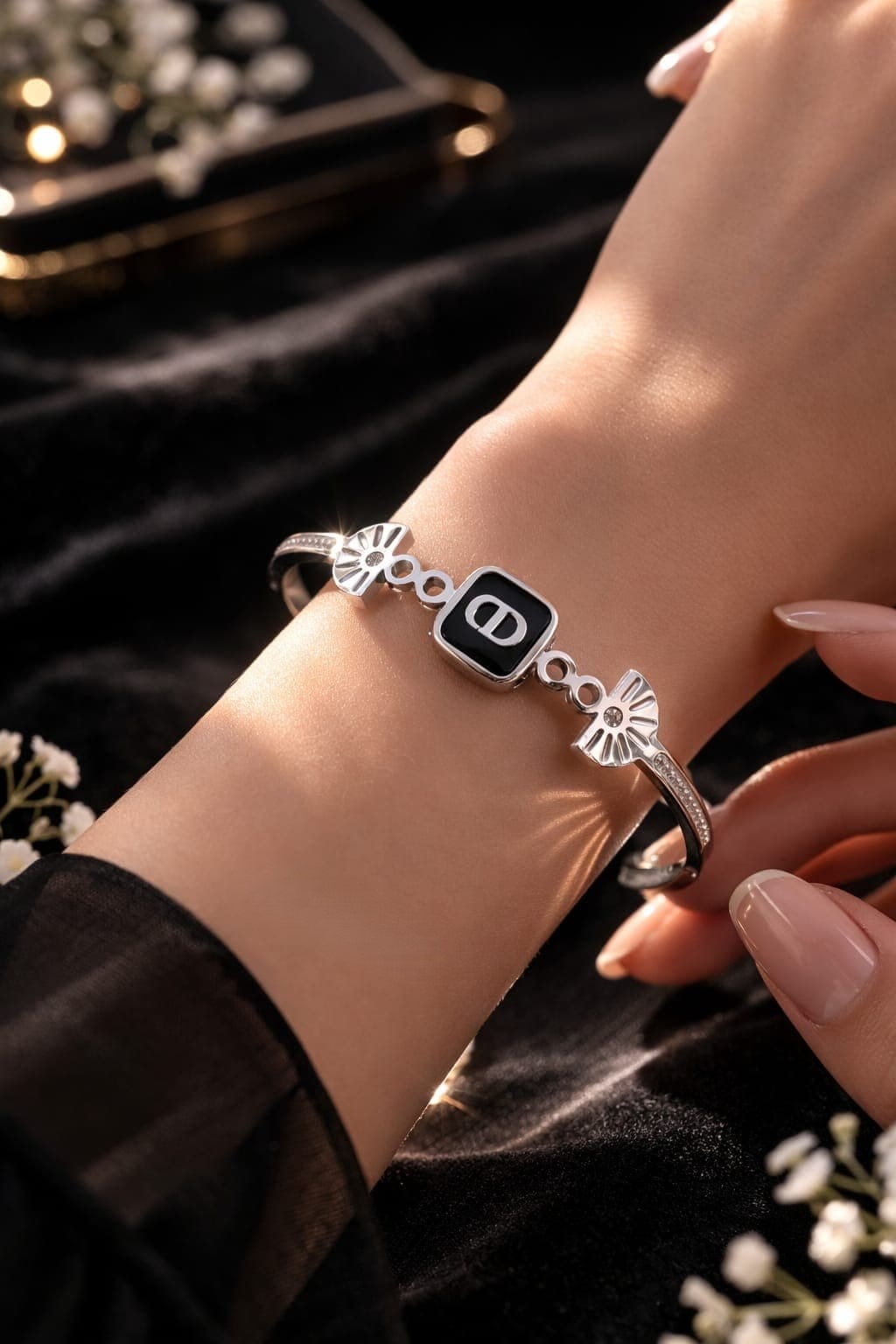 CHRISTIAN DIOR HINGED BRACELET WITH BLACK ENAMEL SQUARE CENTER PLATE SHOWCASING THE ICONIC "CD"SIGNARURE.
