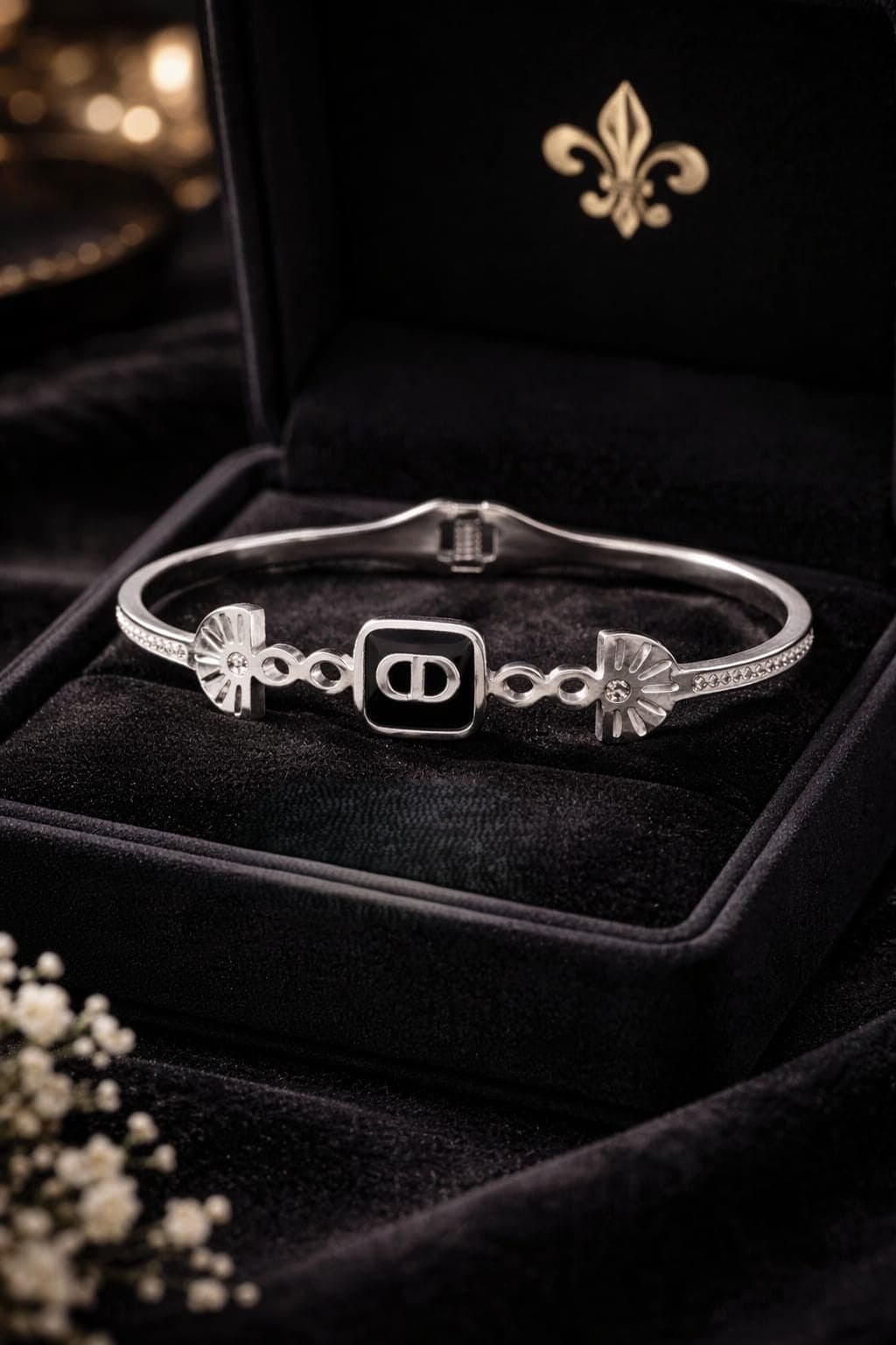 CHRISTIAN DIOR HINGED BRACELET WITH BLACK ENAMEL SQUARE CENTER PLATE SHOWCASING THE ICONIC "CD"SIGNARURE.
