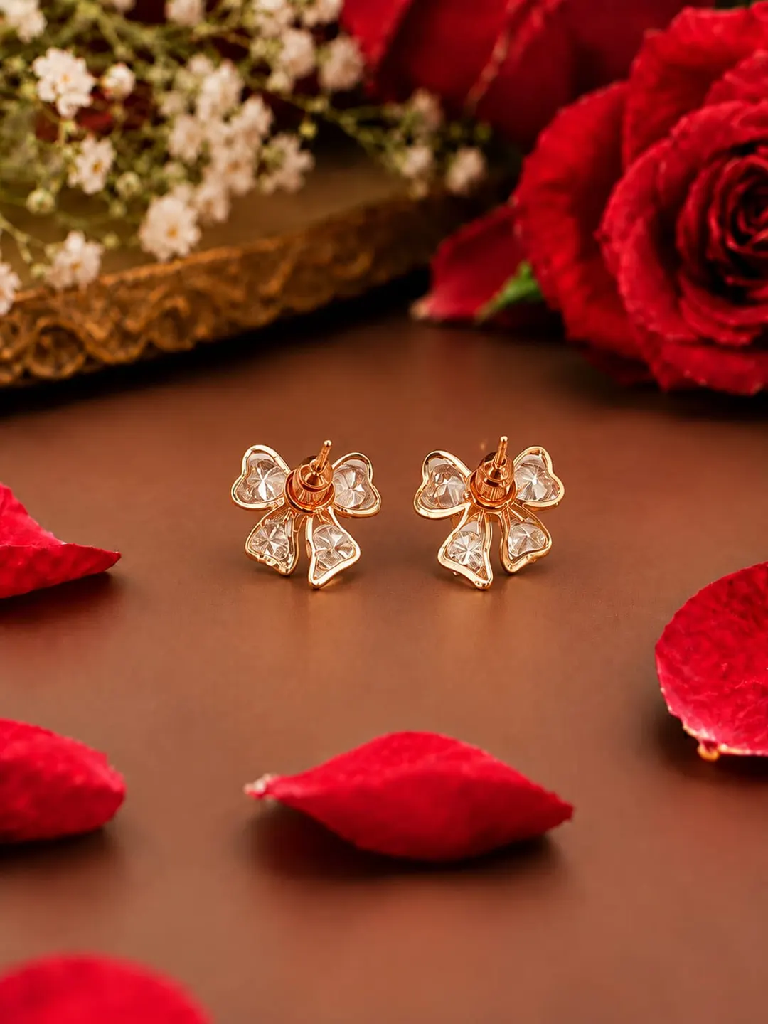 ROSE GOLD CRYSTAL BOW EARRINGS.
