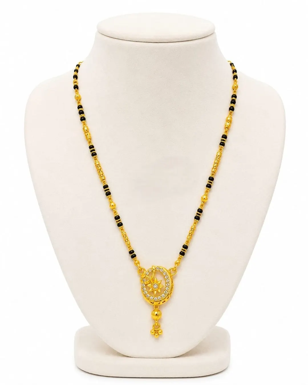 ELEGANT GOLD-TONED BLACK BEADED MANGALSUTRA NECKLACE WITH OVAL FLORAL PENDANT AND DANGLING CHARM