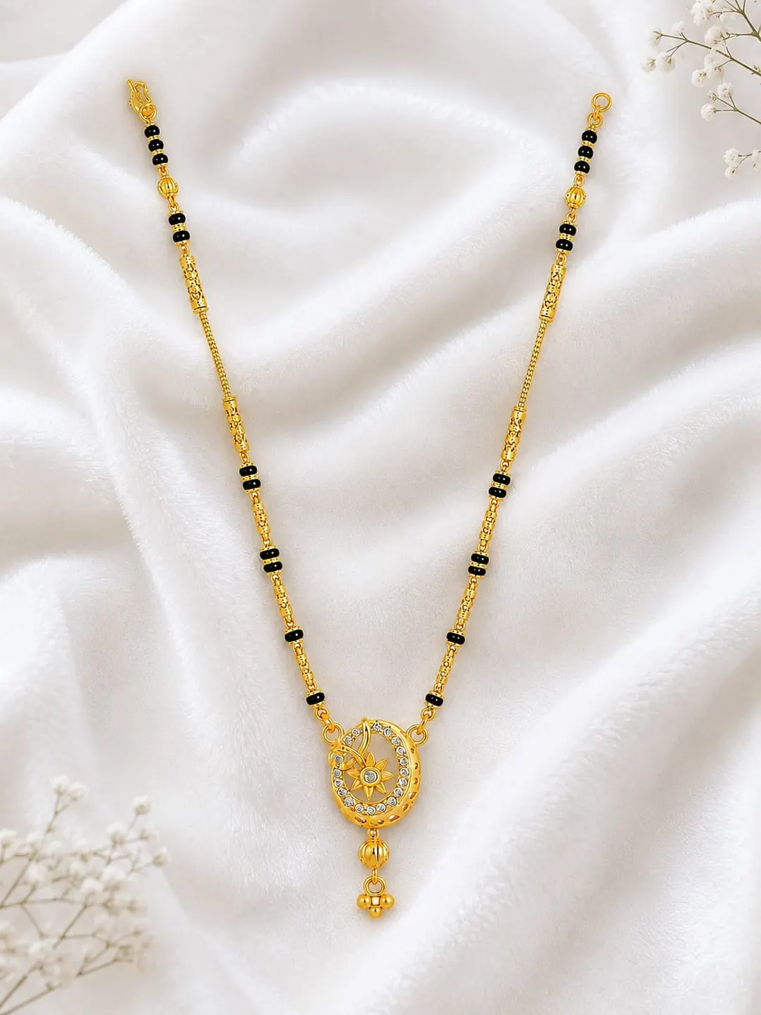 ELEGANT GOLD-TONED BLACK BEADED MANGALSUTRA NECKLACE WITH OVAL FLORAL PENDANT AND DANGLING CHARM