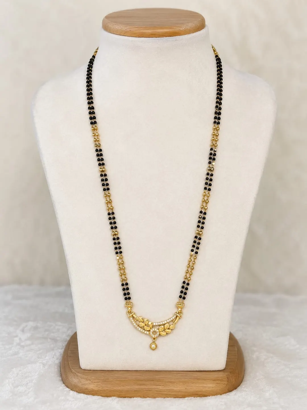 ELEGANT GOLD-TONE DOUBLE-LINE BLACK BEADED MANGALSUTRA WITH TRADITIONAL FLORAL DROP PENDANT