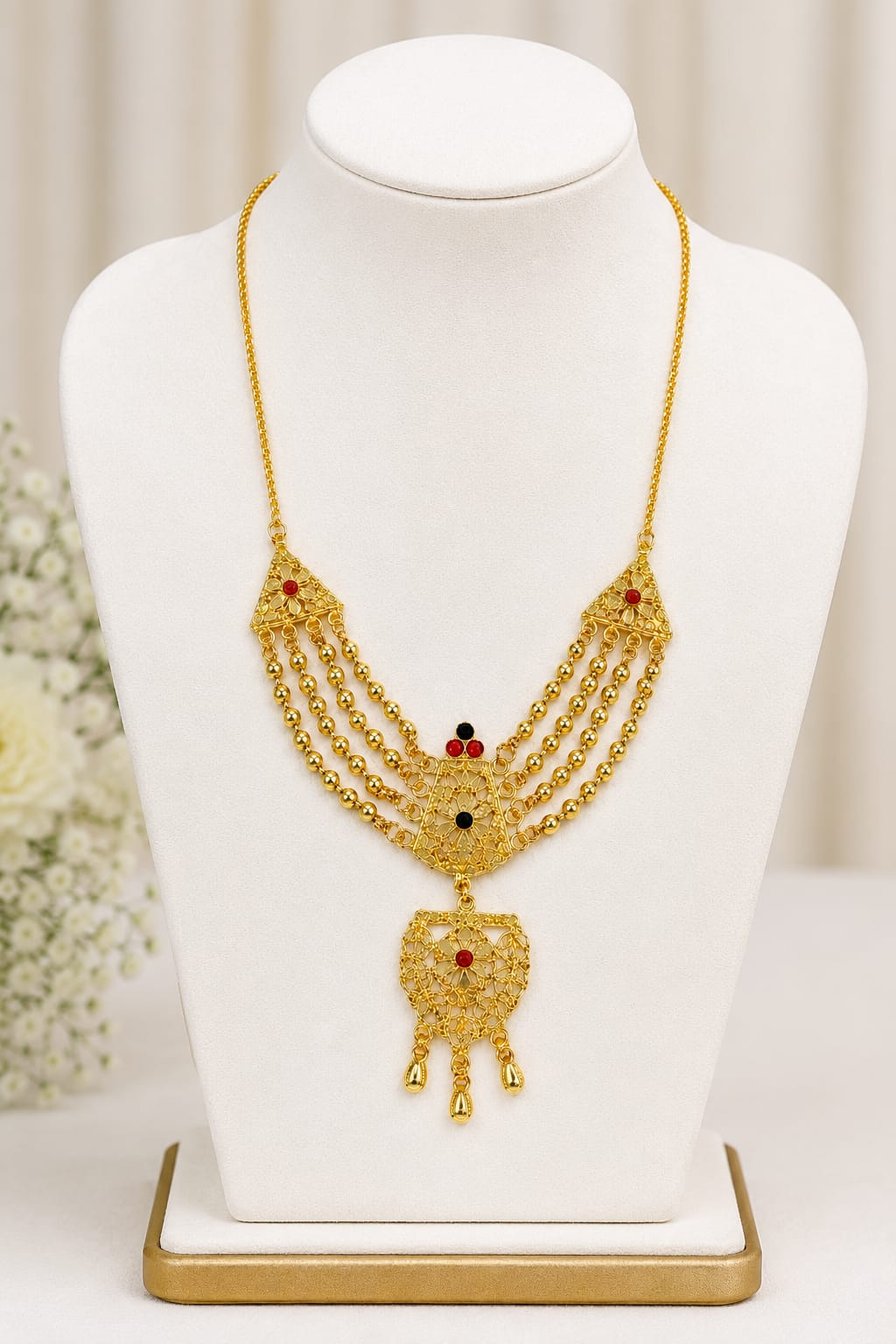 GOLD-TONE MULTI-STRAND RANI HAAR NECKLACE WITH RED & GREEN STONE ACCENTS AND ORNATE DANGLING PENDANT