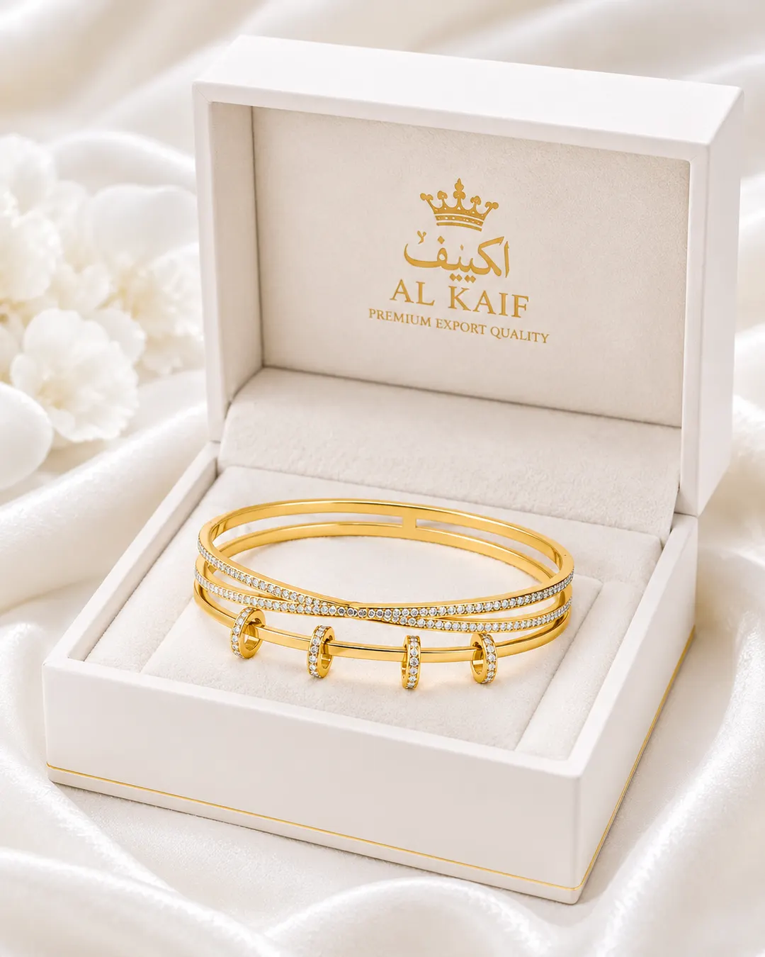 GOLD TONE CROSSOVER CUFF WITH SLIDING RING CHARMS.