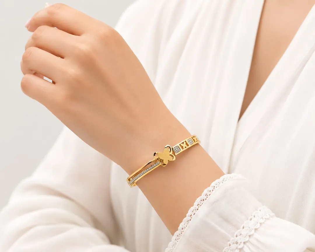GOLD TONE BUTTERFLY MOTIF EMBELLISHED BRACELET.
