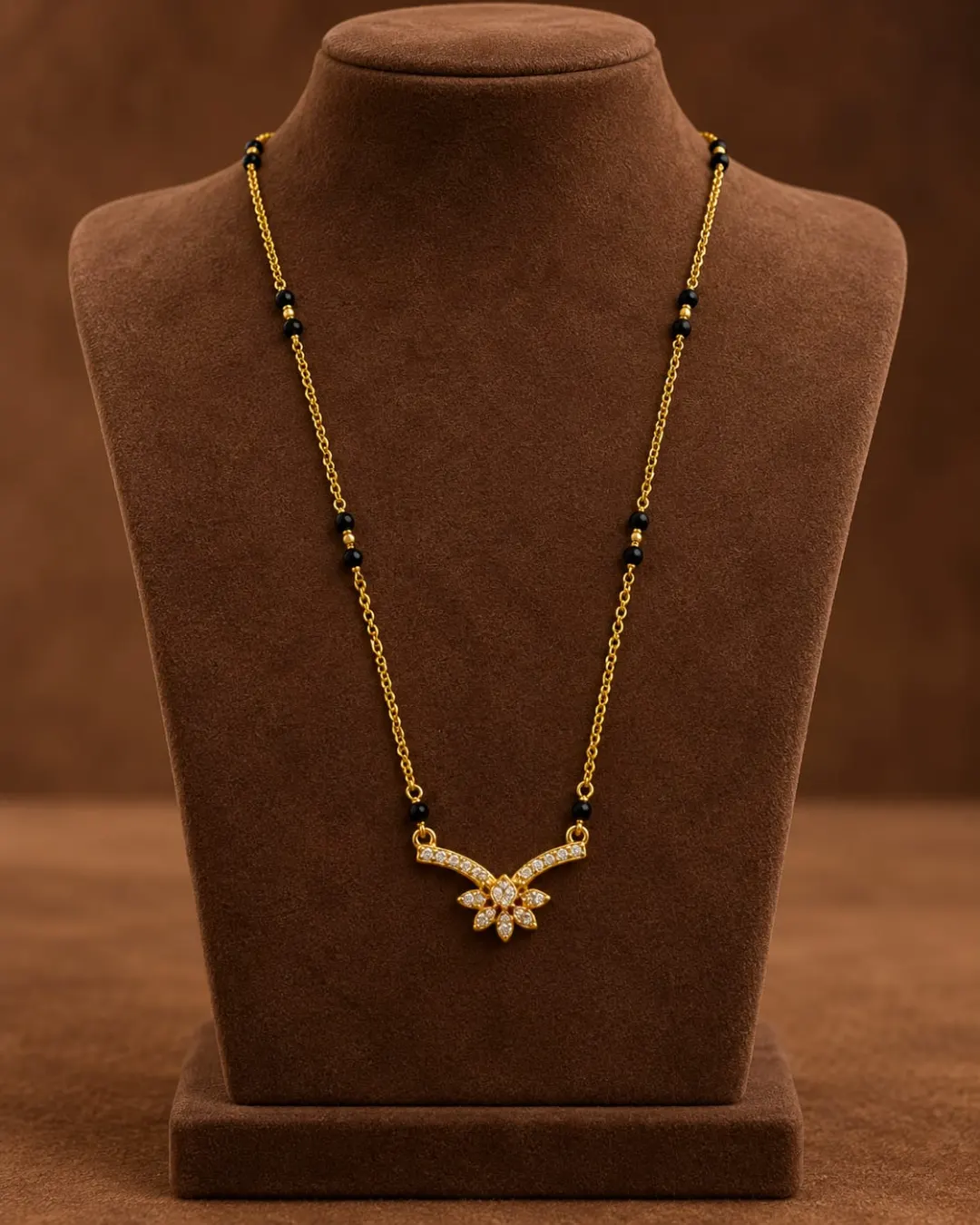 GOLD PLATED BLACK BEADS MANGALSUTRA WITH SPARKLING AD STONES FLORAL PENDANT