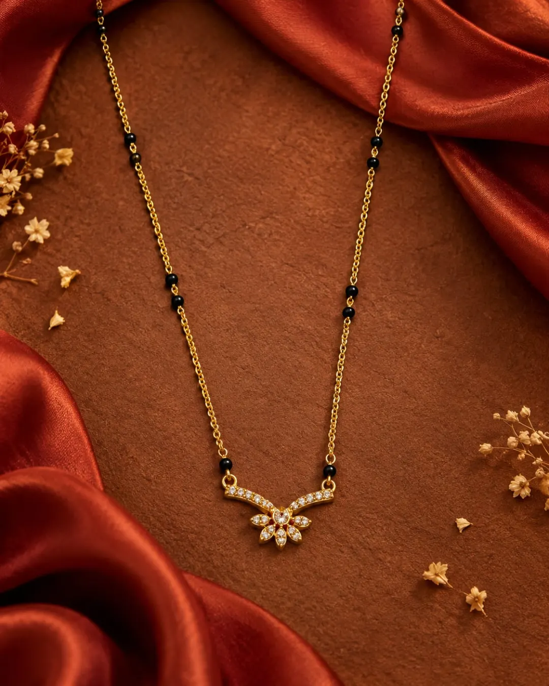 GOLD PLATED BLACK BEADS MANGALSUTRA WITH SPARKLING AD STONES FLORAL PENDANT